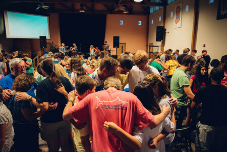 Students have a time of prayer and worship before and after service projects.